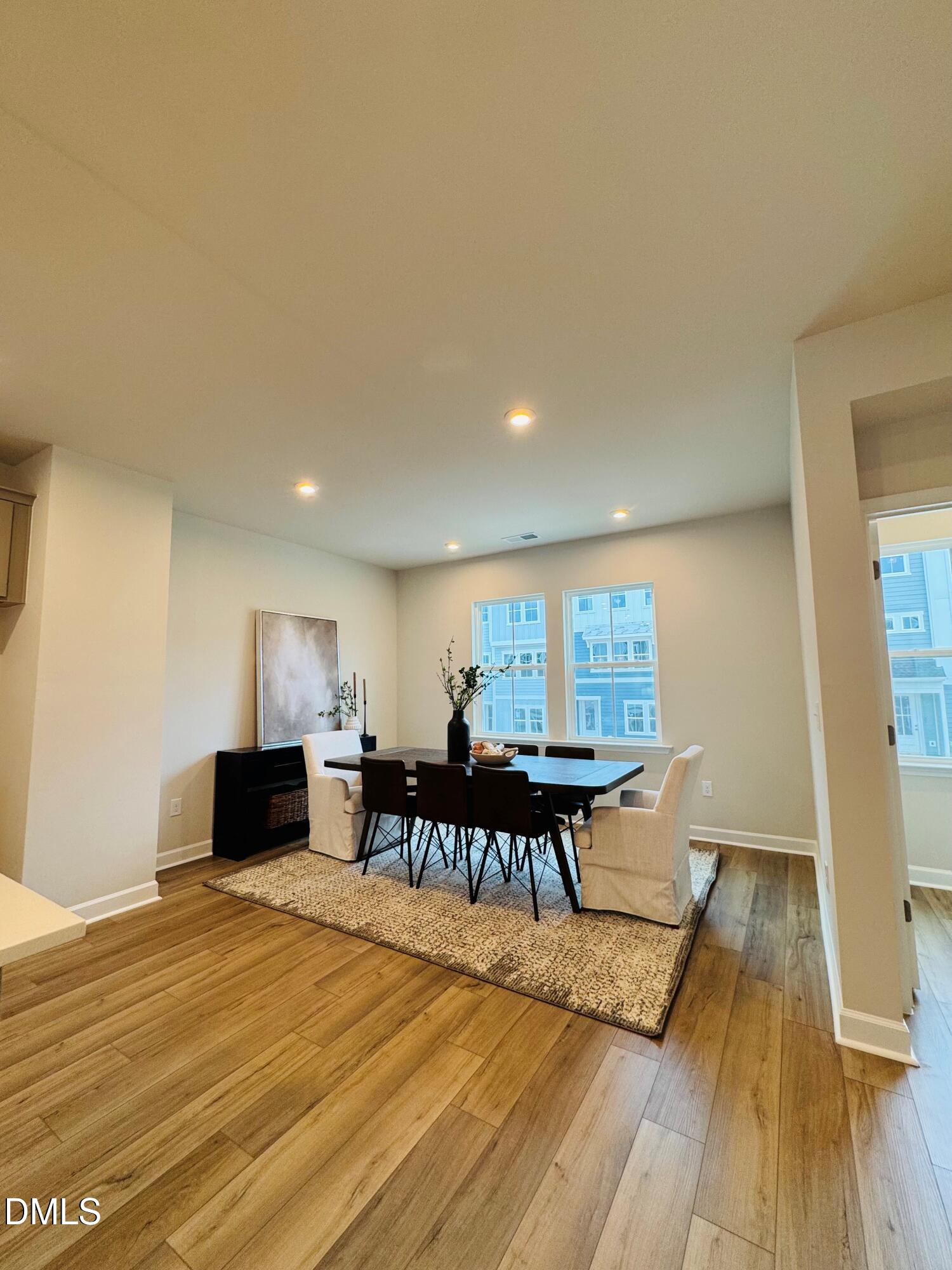 706 Hyperion Alley Wake Forest, NC 27587 - Photo 14 of 67 a view of a dining room with furniture and wooden floor