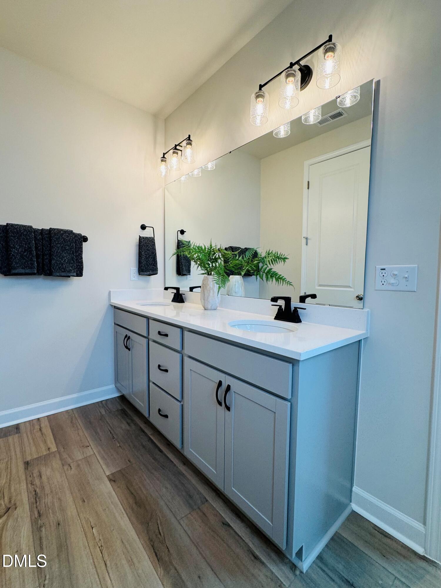 706 Hyperion Alley Wake Forest, NC 27587 - Photo 18 of 67 a spacious bathroom with a double vanity sink and a mirror