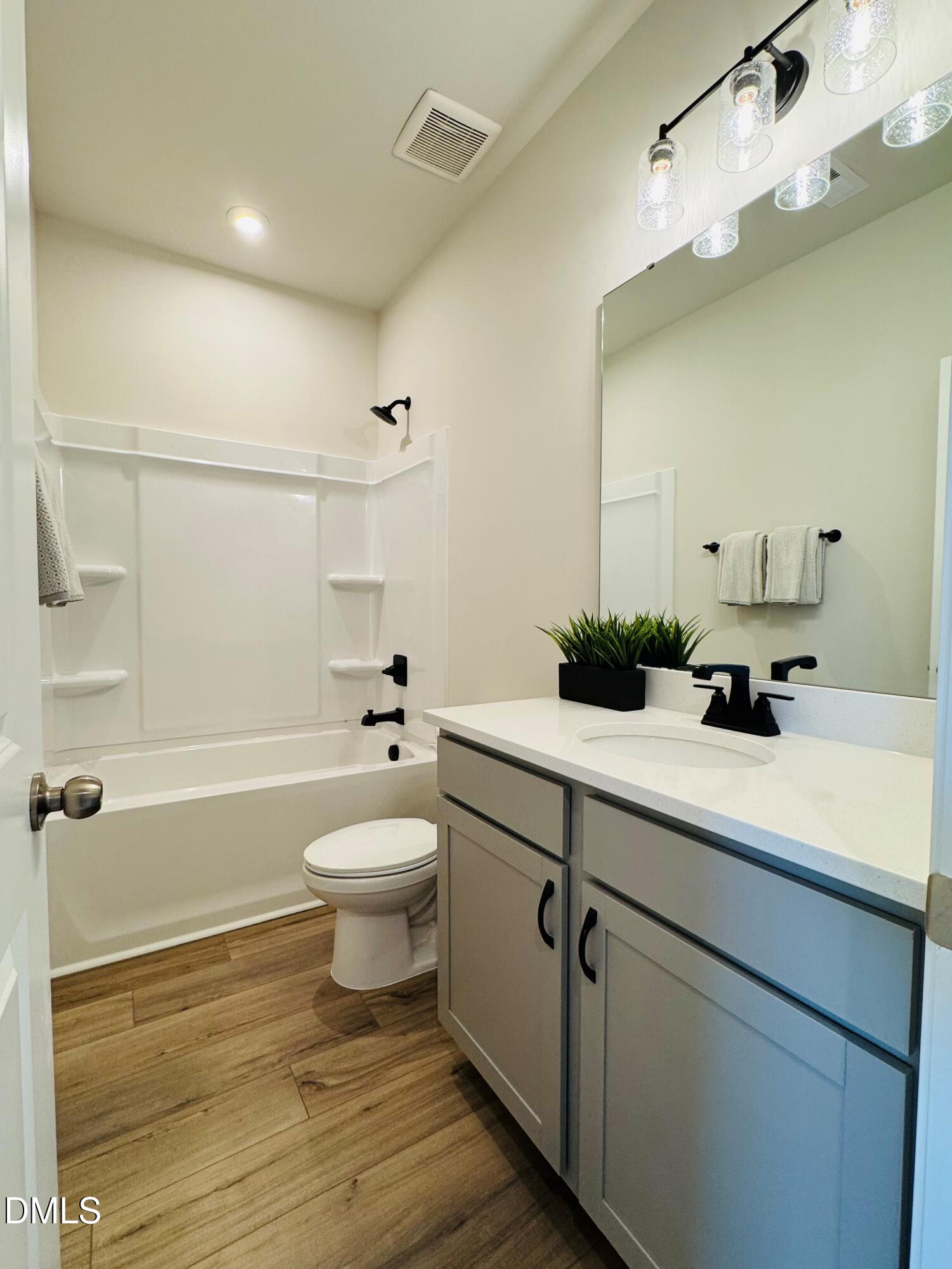 706 Hyperion Alley Wake Forest, NC 27587 - Photo 21 of 67 a bathroom with a sink a toilet and shower