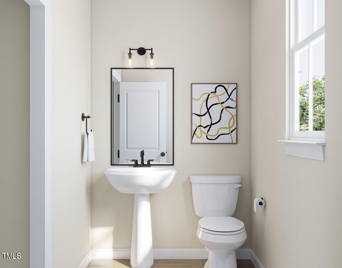 706 Hyperion Alley Wake Forest, NC 27587 - Photo 24 of 65 a bathroom with a toilet sink and mirror