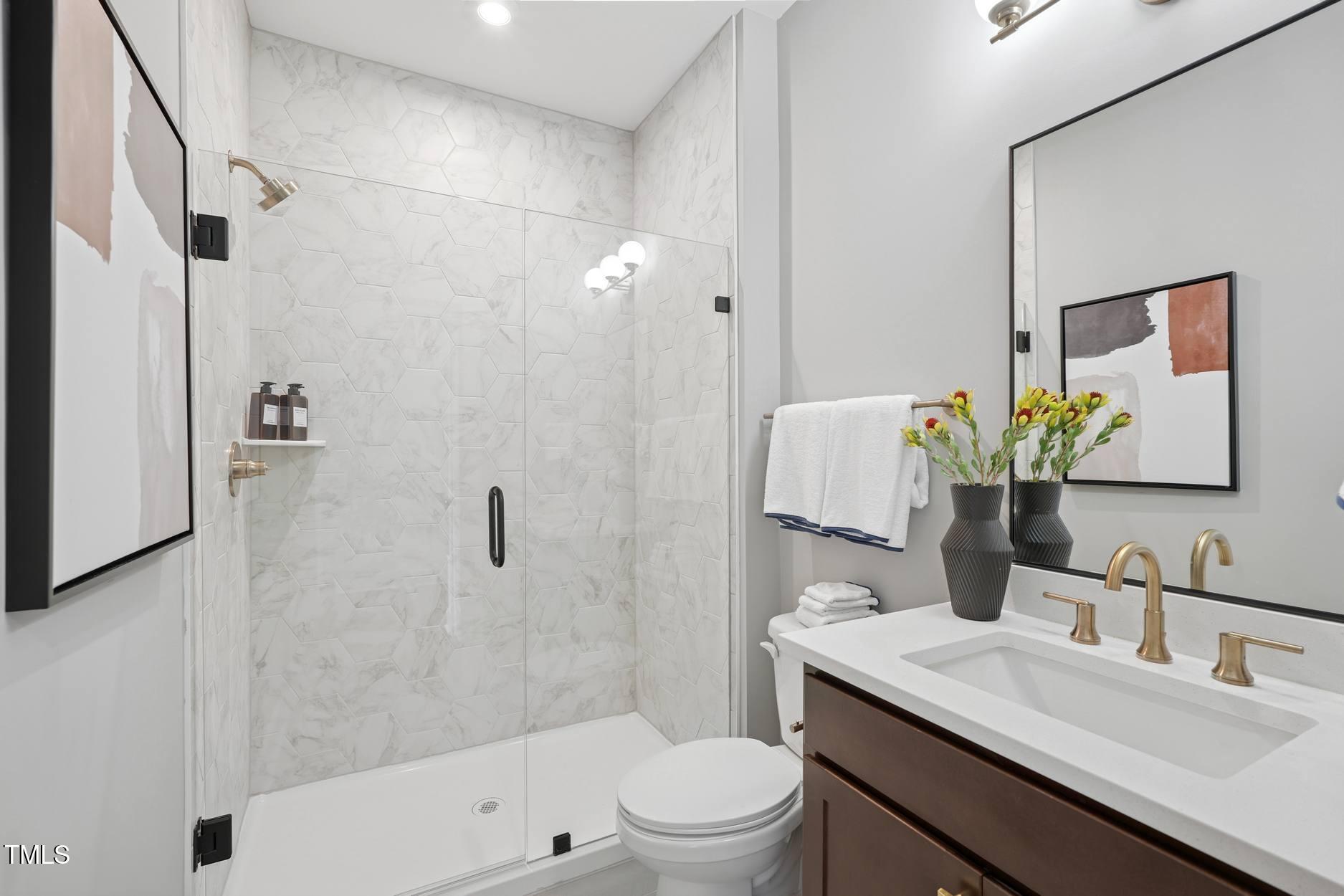 706 Hyperion Alley Wake Forest, NC 27587 - Photo 49 of 67 a bathroom with a sink toilet and shower