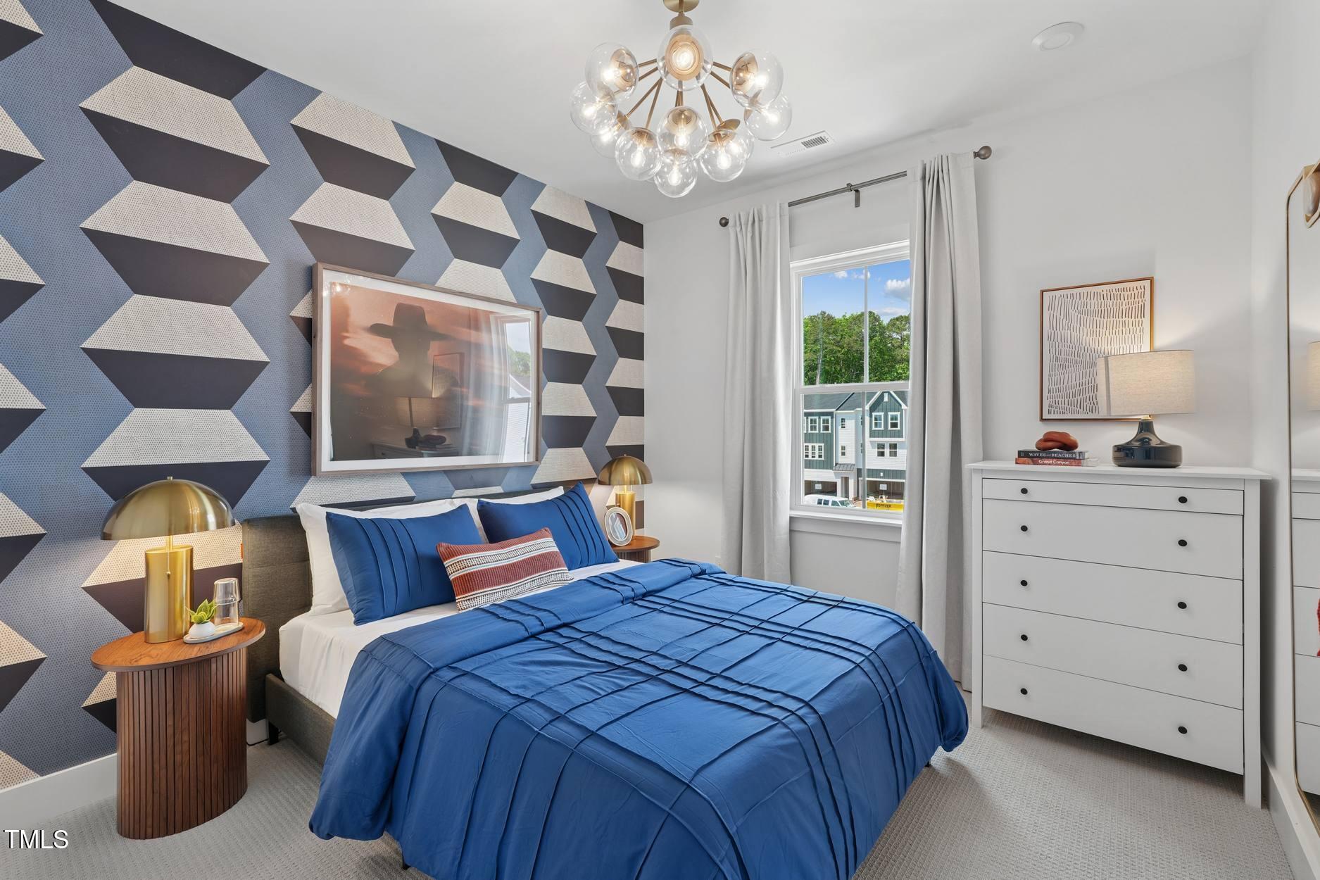 706 Hyperion Alley Wake Forest, NC 27587 - Photo 50 of 65 a bedroom with a large bed and a chandelier