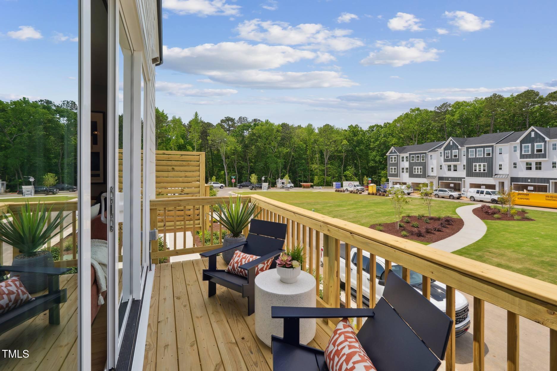 706 Hyperion Alley Wake Forest, NC 27587 - Photo 54 of 67 a view of a balcony with two chairs and a table
