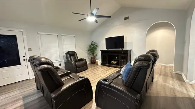 a living room with furniture and a flat screen tv