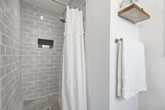 a bathroom with a shower and a sink