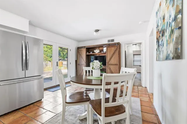 a dining room with furniture and wooden floor