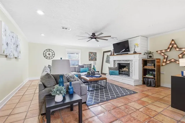 a living room with furniture a fireplace and a flat screen tv