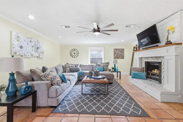 a living room with furniture a flat screen tv and a fireplace