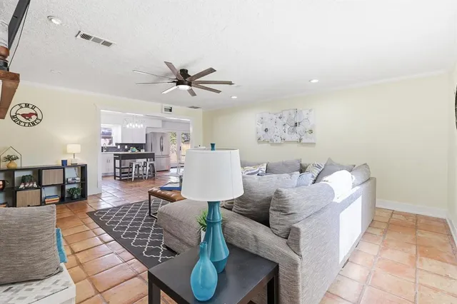 a living room with furniture and kitchen view