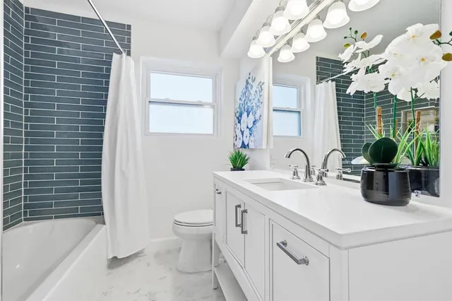 a bathroom with a sink a toilet and bathtub