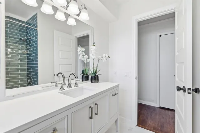 a bathroom with a sink a vanity and a mirror