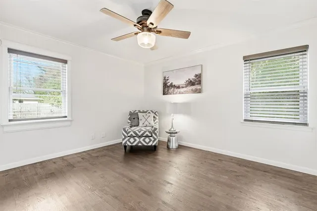 a view of a room with wooden floor and window