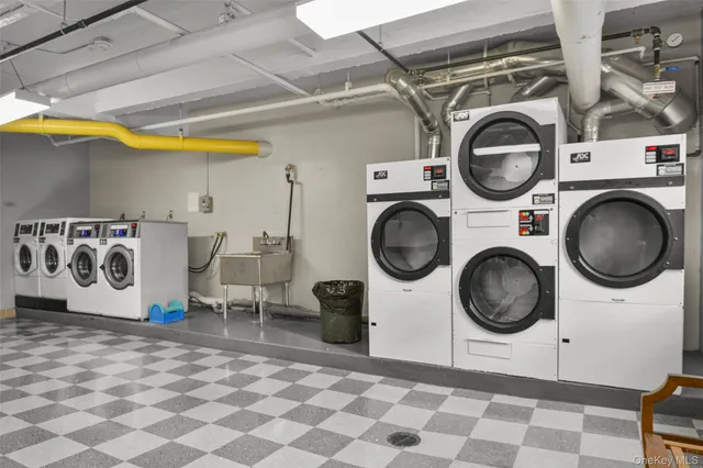 a utility room with dryer washer and a view of kitchen