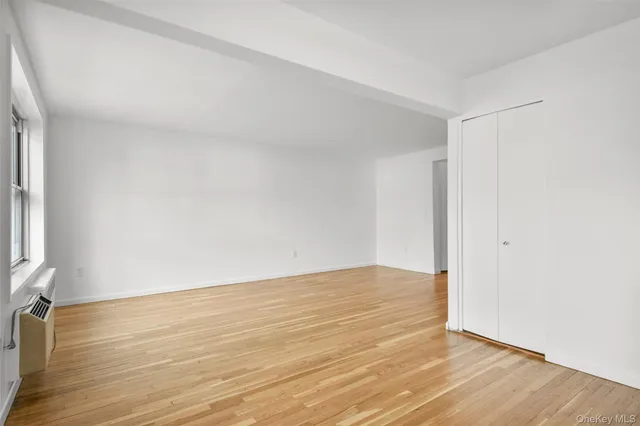 a view of an empty room and wooden floor