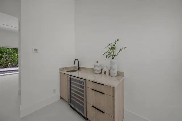 a living room with couches and kitchen view