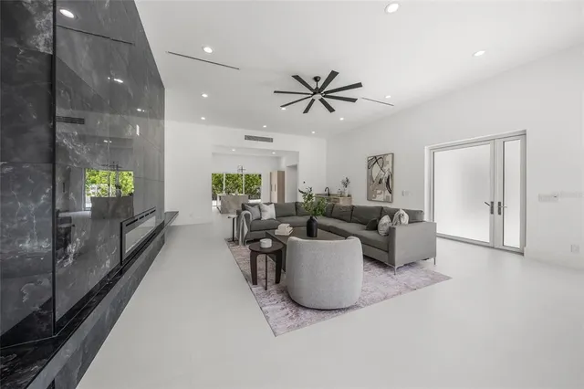 a bedroom with a large bed and a potted plant