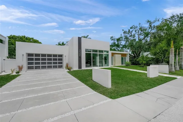 a view of house with backyard space and balcony