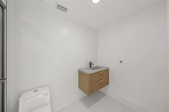a kitchen with kitchen island a large counter top space and stainless steel appliances