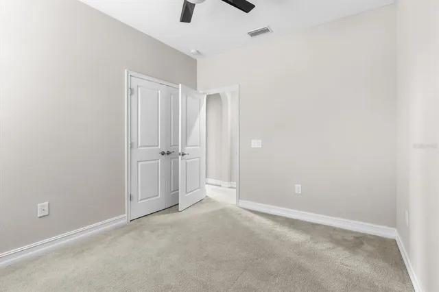 an empty room with closet and a window