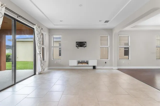 a view of a livingroom with an empty space and a window