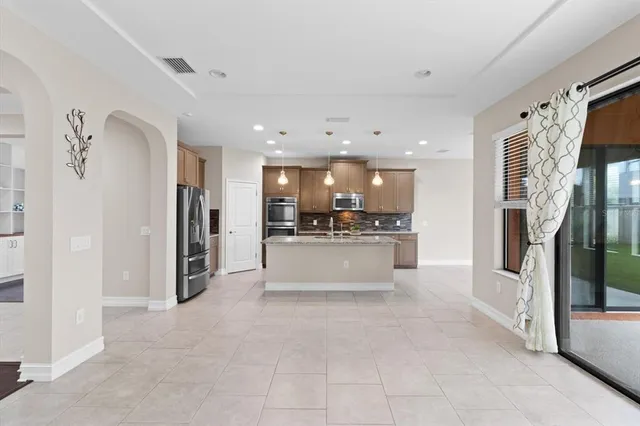 a large white kitchen with white cabinets and stainless steel appliances