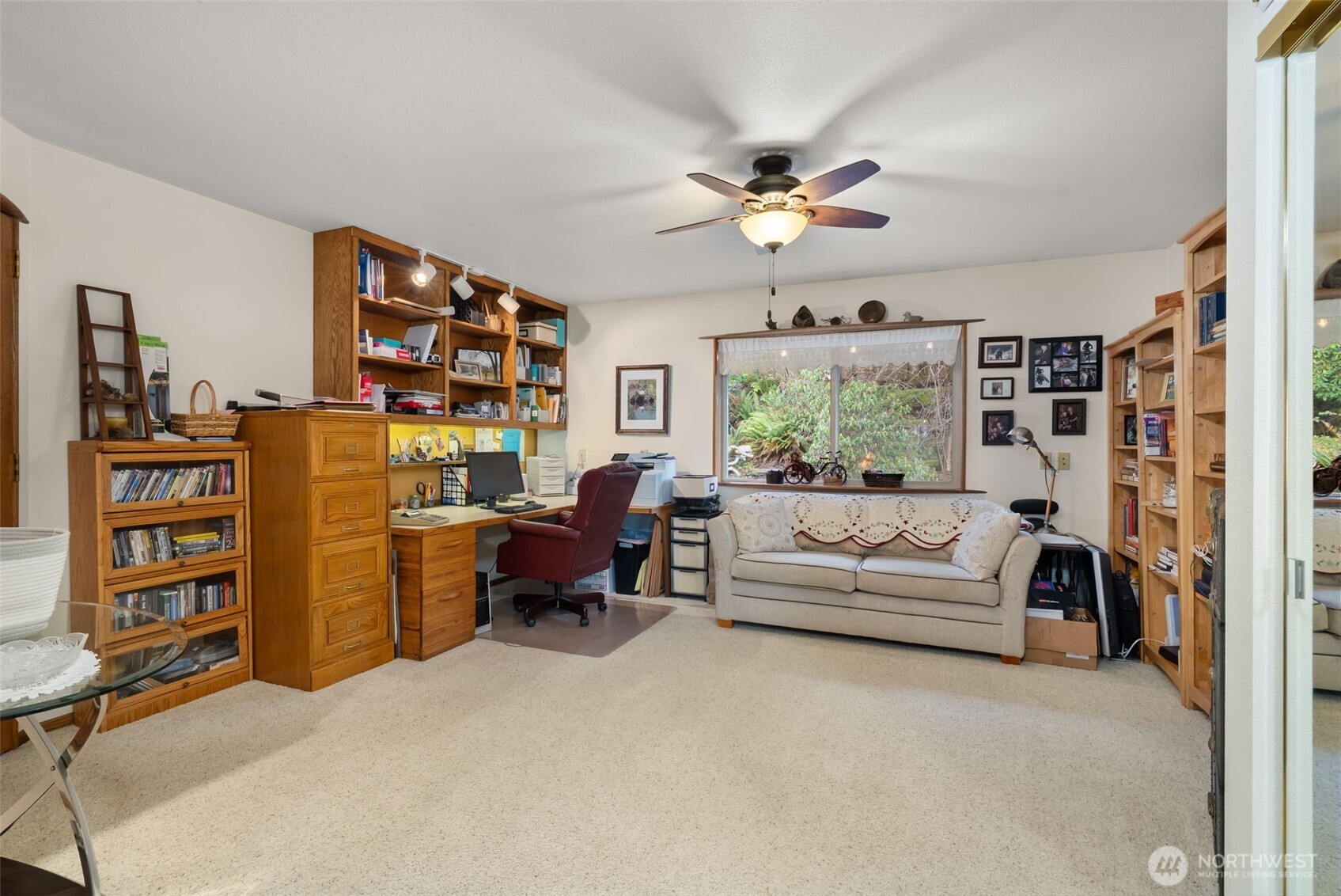 65 Wilderness Road Oakville, WA 98568 - Photo 14 of 40 a living room with furniture a bookshelf and a window