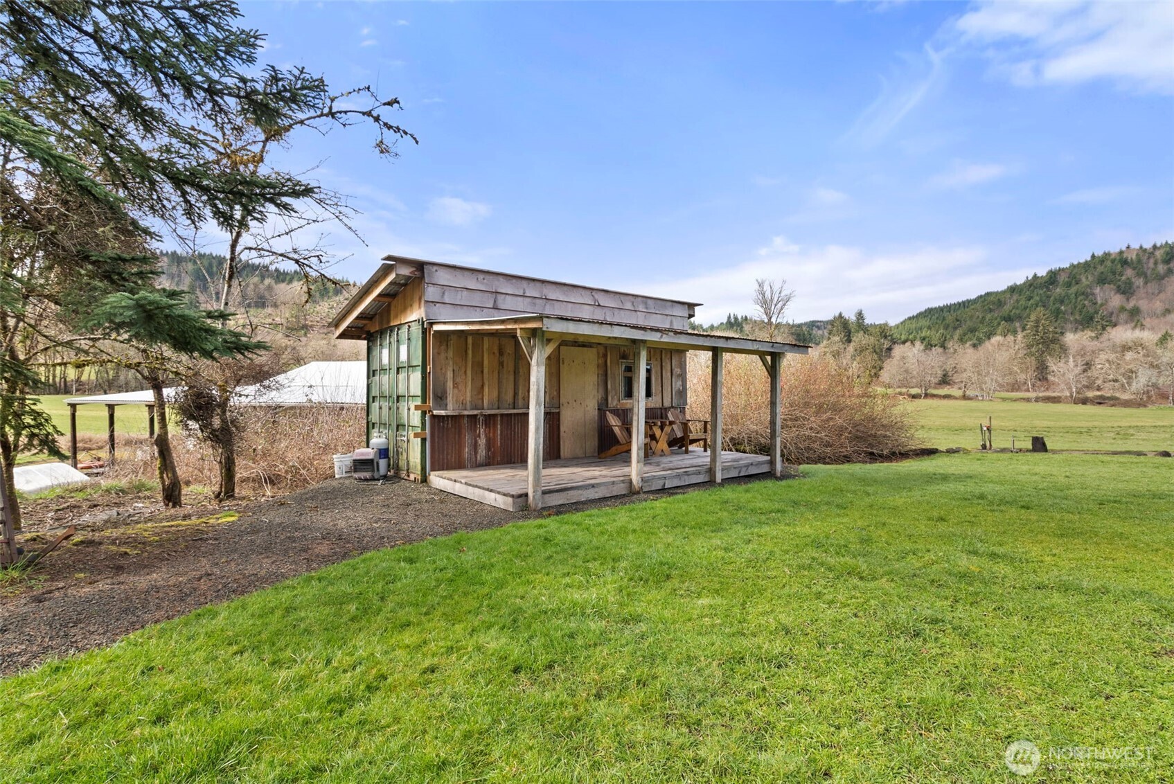 65 Wilderness Road Oakville, WA 98568 - Photo 28 of 40 a view of a house with a yard and sitting area