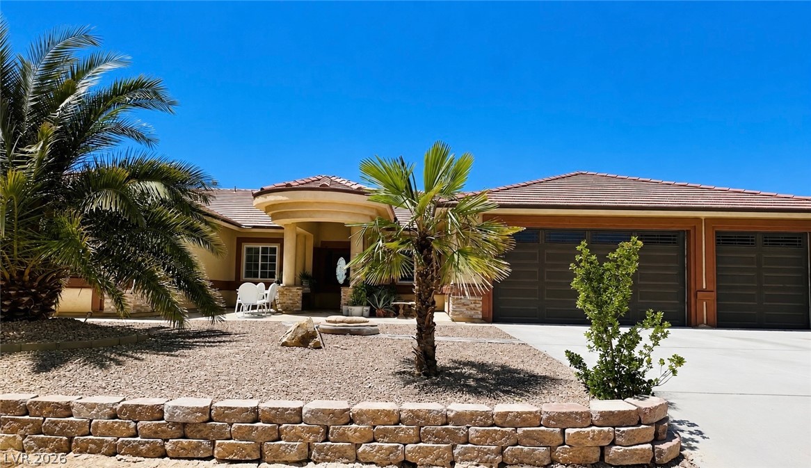 A desert oasis welcomes you home with a private patio and attached garage, perfect for tranquil living.