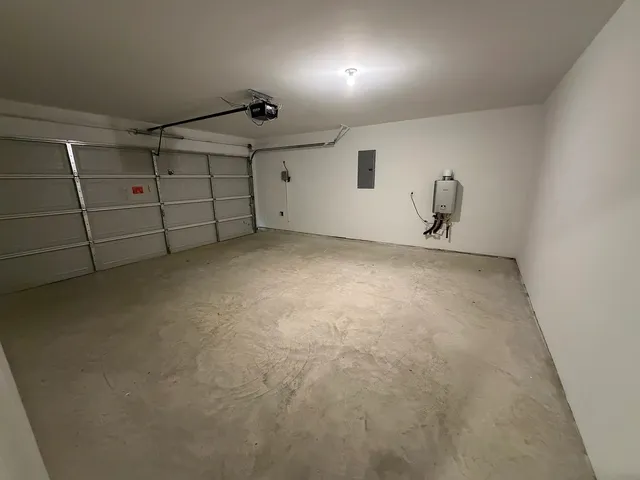 a view of a room with wooden floor and cabinets
