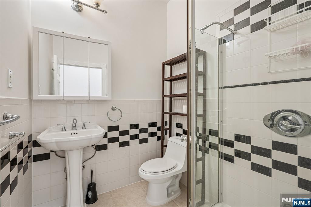 90 A Hackensack Plank Road Weehawken, NJ 07086 - Photo 26 of 40 a bathroom with a sink toilet and shower