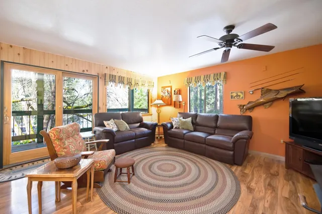 a spacious bedroom with a bed and wooden floor