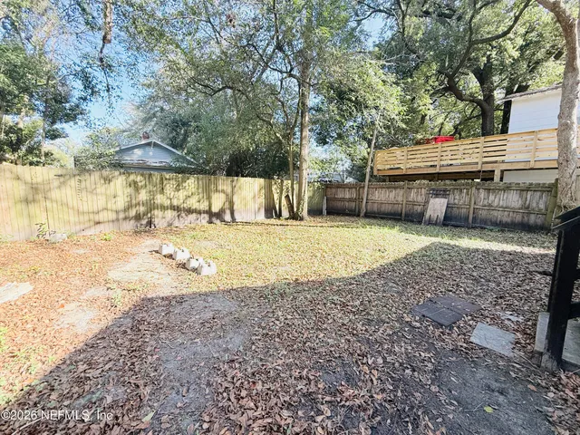 a view of a house with a yard covered in snow