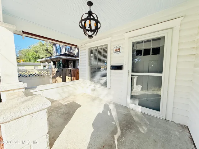 a living room with wooden floors and a fireplace