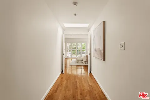 a view of a room with wooden floor