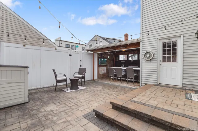 a view of a patio with a table and chairs and wooden floor