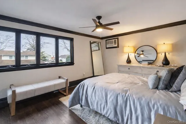 a bedroom with a bed and a large window with the outer view