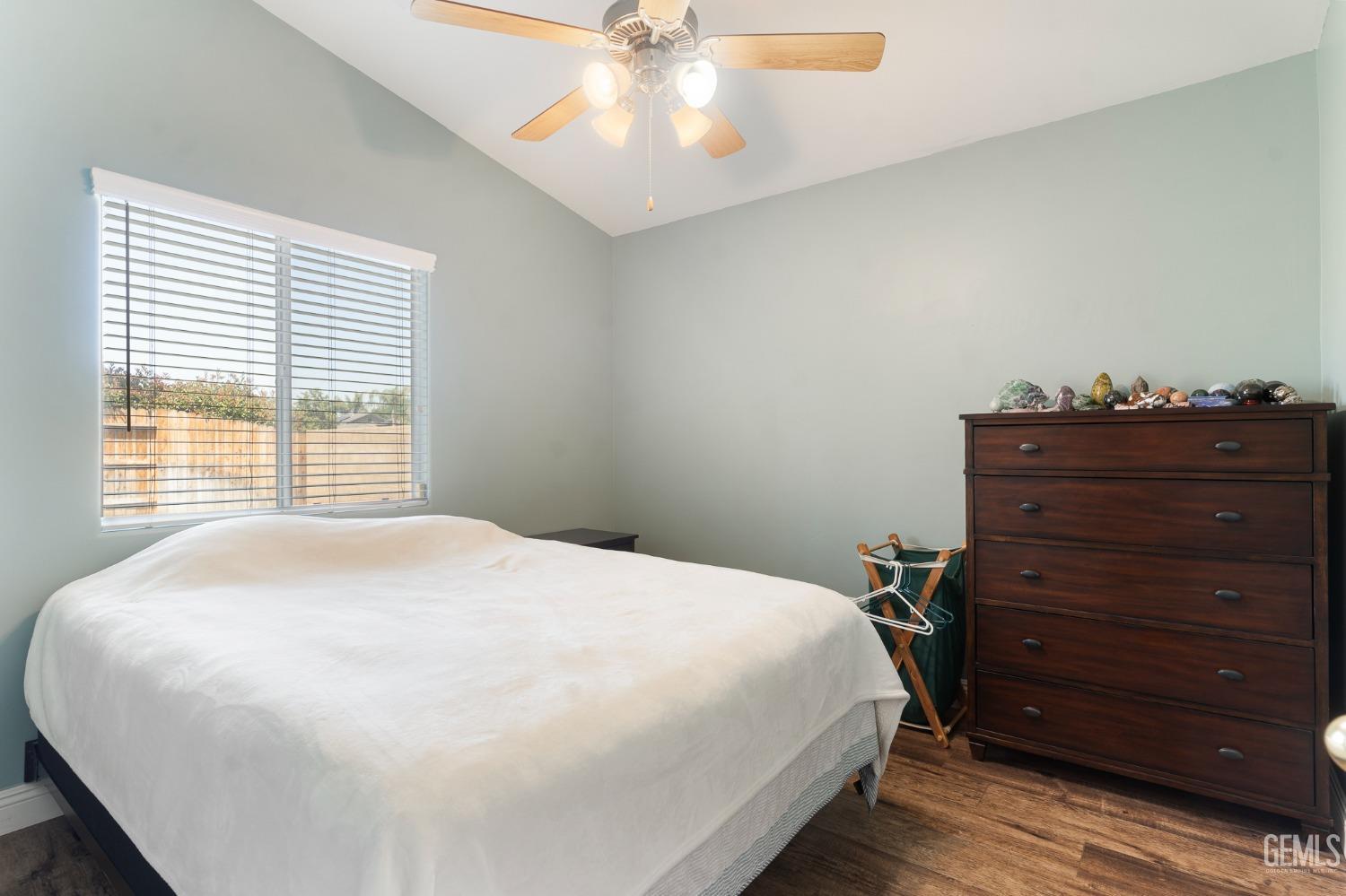 Undisclosed Address Bakersfield, CA 93311 - Photo 12 of 17 a large bed sitting in a bedroom next to a window and dresser