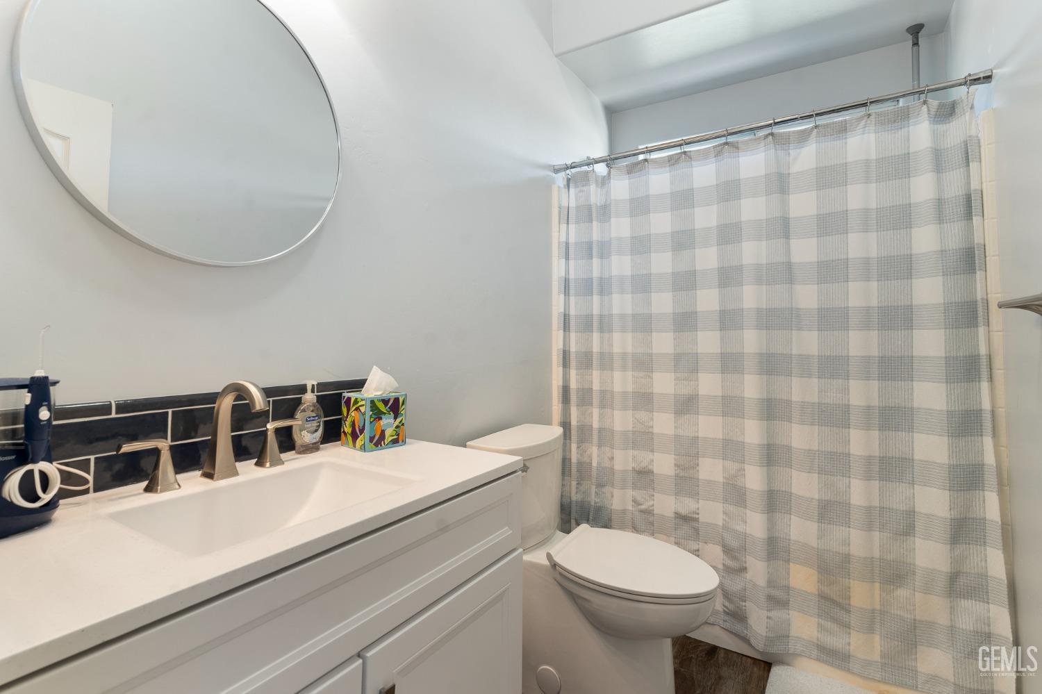Undisclosed Address Bakersfield, CA 93311 - Photo 13 of 17 a bathroom with a sink a toilet and a mirror