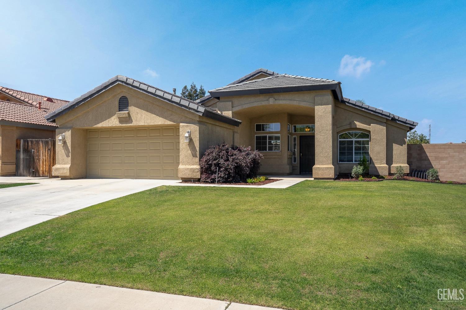 Undisclosed Address Bakersfield, CA 93311 - Photo 2 of 17 a front view of a house with a garden