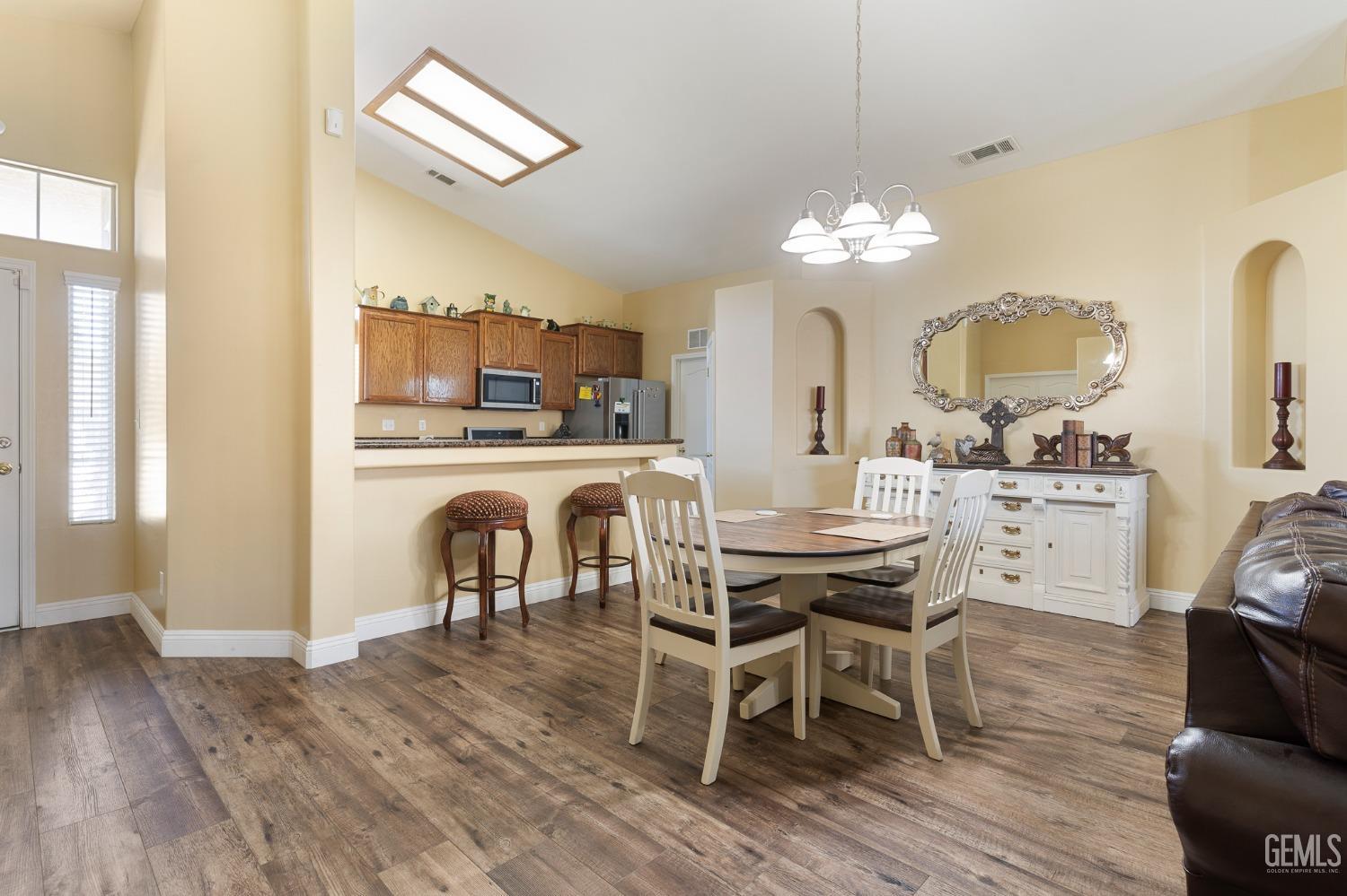 Undisclosed Address Bakersfield, CA 93311 - Photo 6 of 17 a view of a dining room with furniture and wooden floor