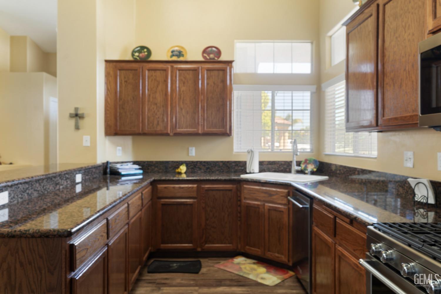 Undisclosed Address Bakersfield, CA 93311 - Photo 8 of 17 a kitchen with a sink stove and cabinets
