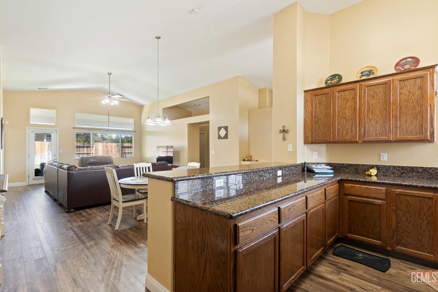 Undisclosed Address Bakersfield, CA 93311 - Photo 9 of 17 a kitchen with granite countertop a sink stove and cabinets