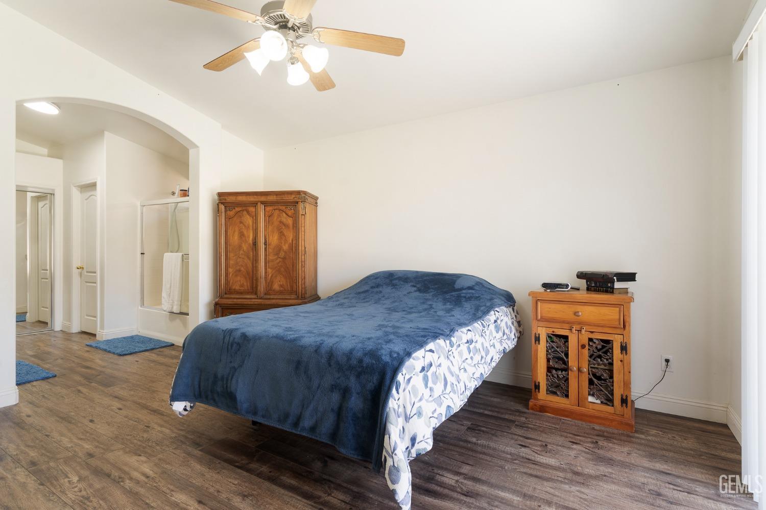 Undisclosed Address Bakersfield, CA 93311 - Photo 10 of 17 a bedroom with a bed and a chandelier