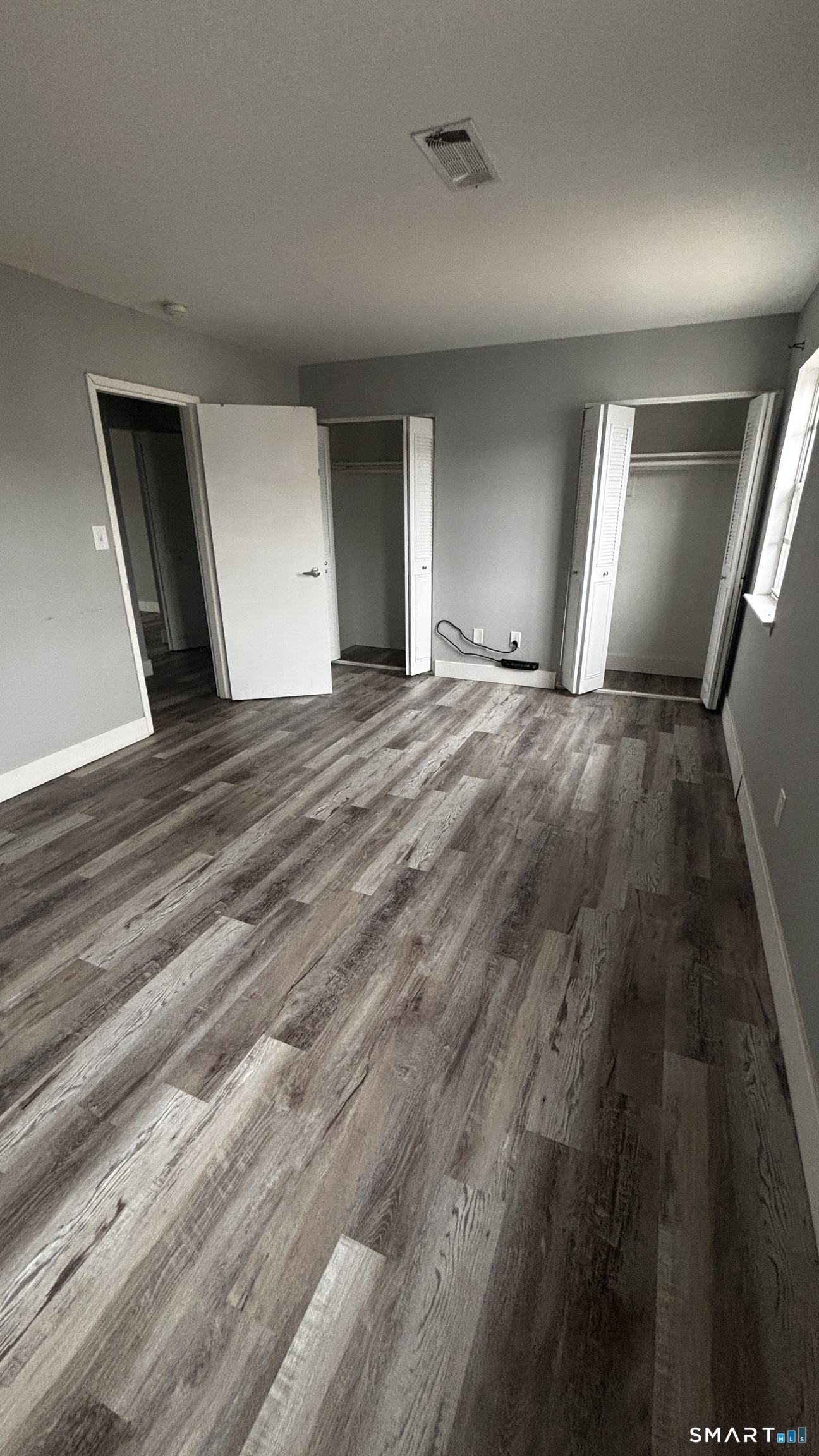 50 Greenhouse Road, Unit 33C Bridgeport, CT 06606 - Photo 11 of 33 a view of empty room with window and fireplace