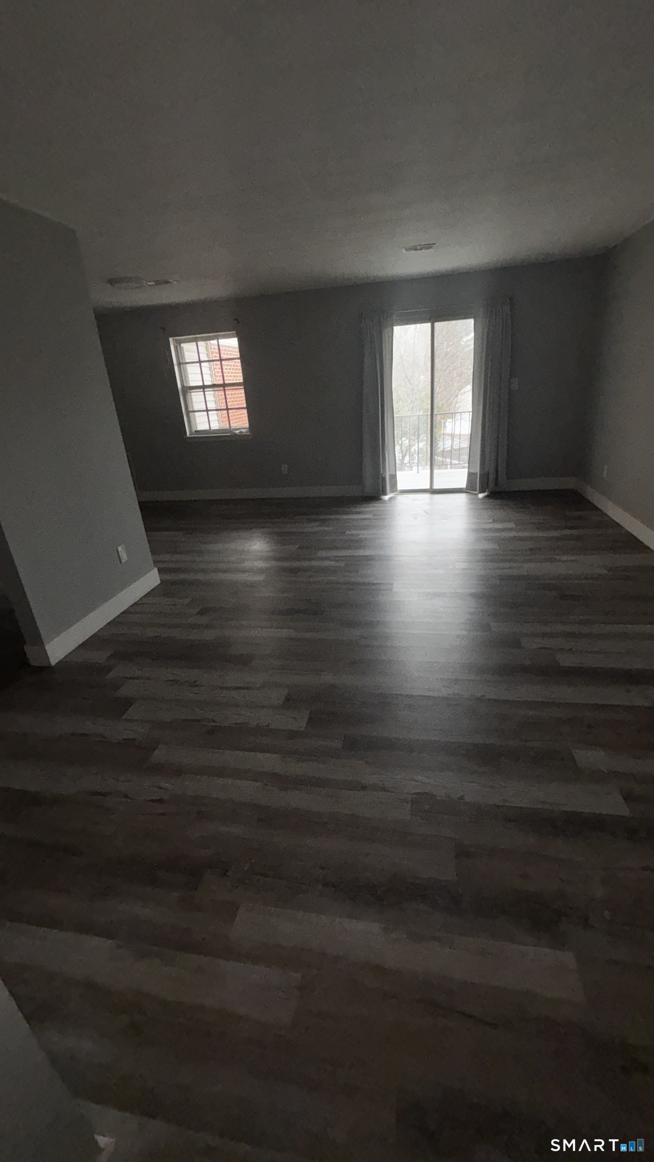 50 Greenhouse Road, Unit 33C Bridgeport, CT 06606 - Photo 21 of 33 a view of an empty room with wooden floor and a window