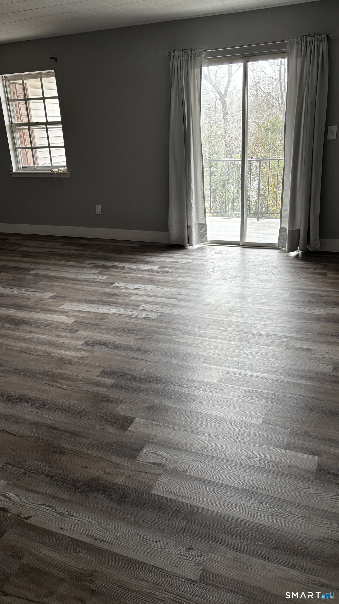 50 Greenhouse Road, Unit 33C Bridgeport, CT 06606 - Photo 6 of 33 a view of an empty room with wooden floor and a window