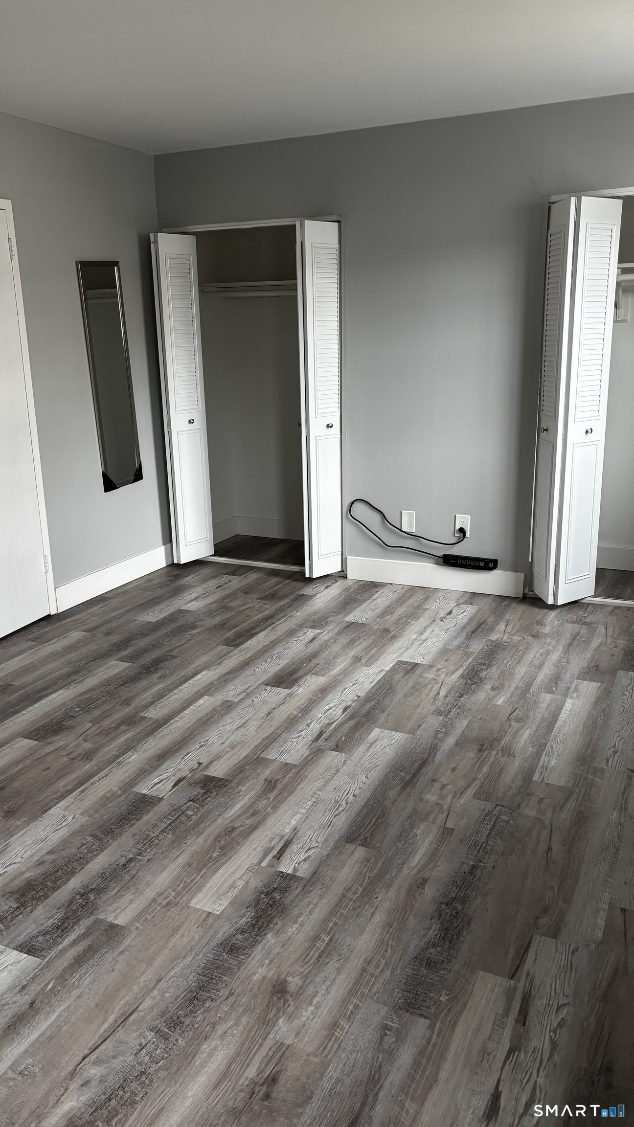 50 Greenhouse Road, Unit 33C Bridgeport, CT 06606 - Photo 9 of 33 a view of an empty room with wooden floor and window