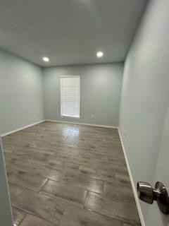 8608 10th Street Lubbock, TX 79416 - Photo 12 of 18 an empty room with wooden floor and natural light