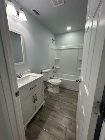 8608 10th Street Lubbock, TX 79416 - Photo 14 of 18 a bathroom with a double vanity sink mirror and toilet
