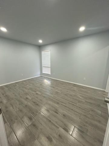 8608 10th Street Lubbock, TX 79416 - Photo 15 of 18 an empty room with wooden floor and windows